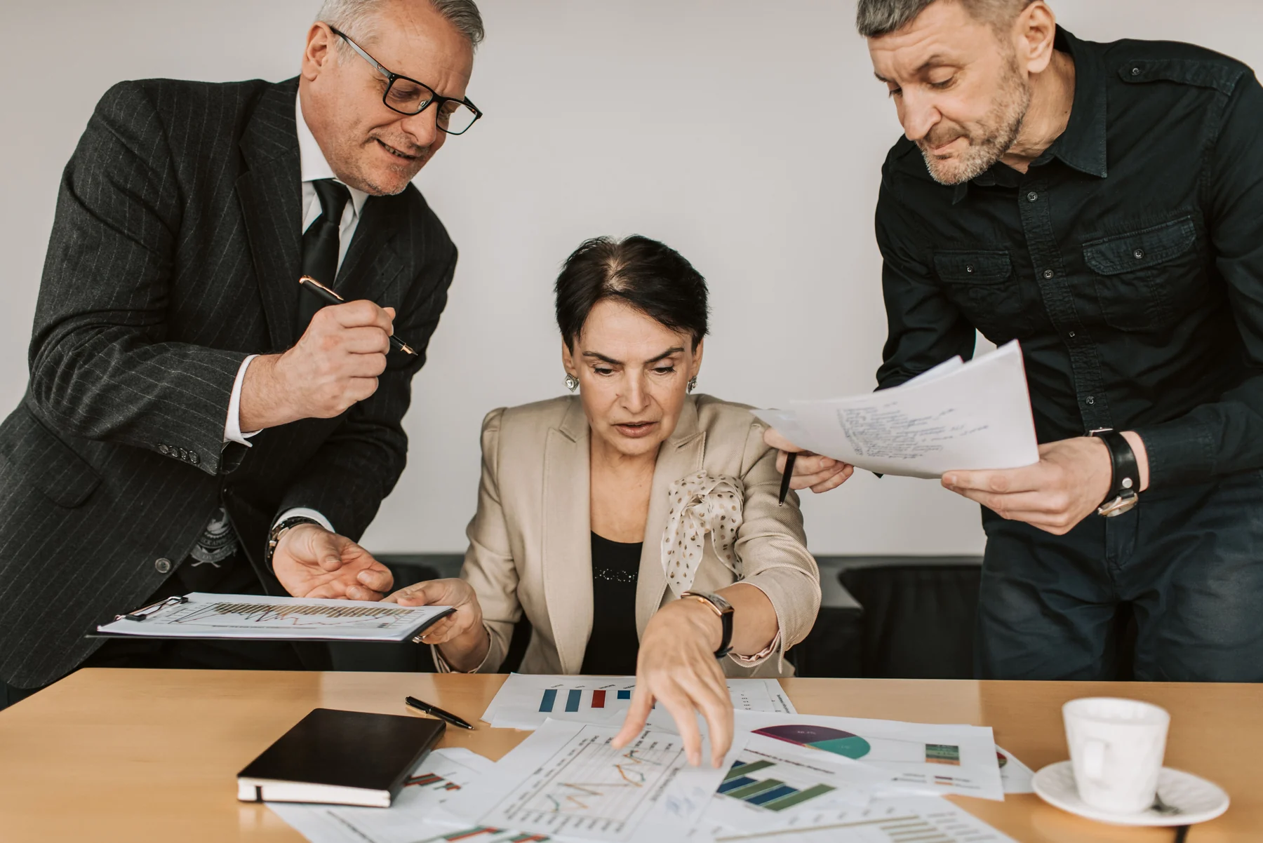 Professional insurance team reviewing financial documents together in an office