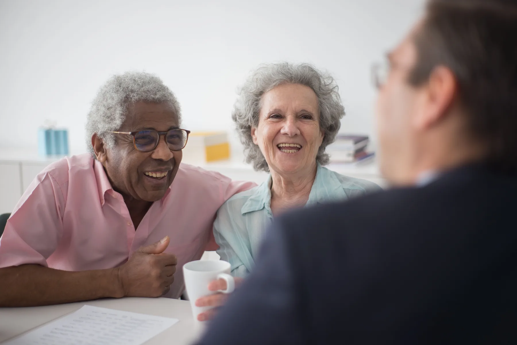 Older couple having a friendly conversation with an advisor
