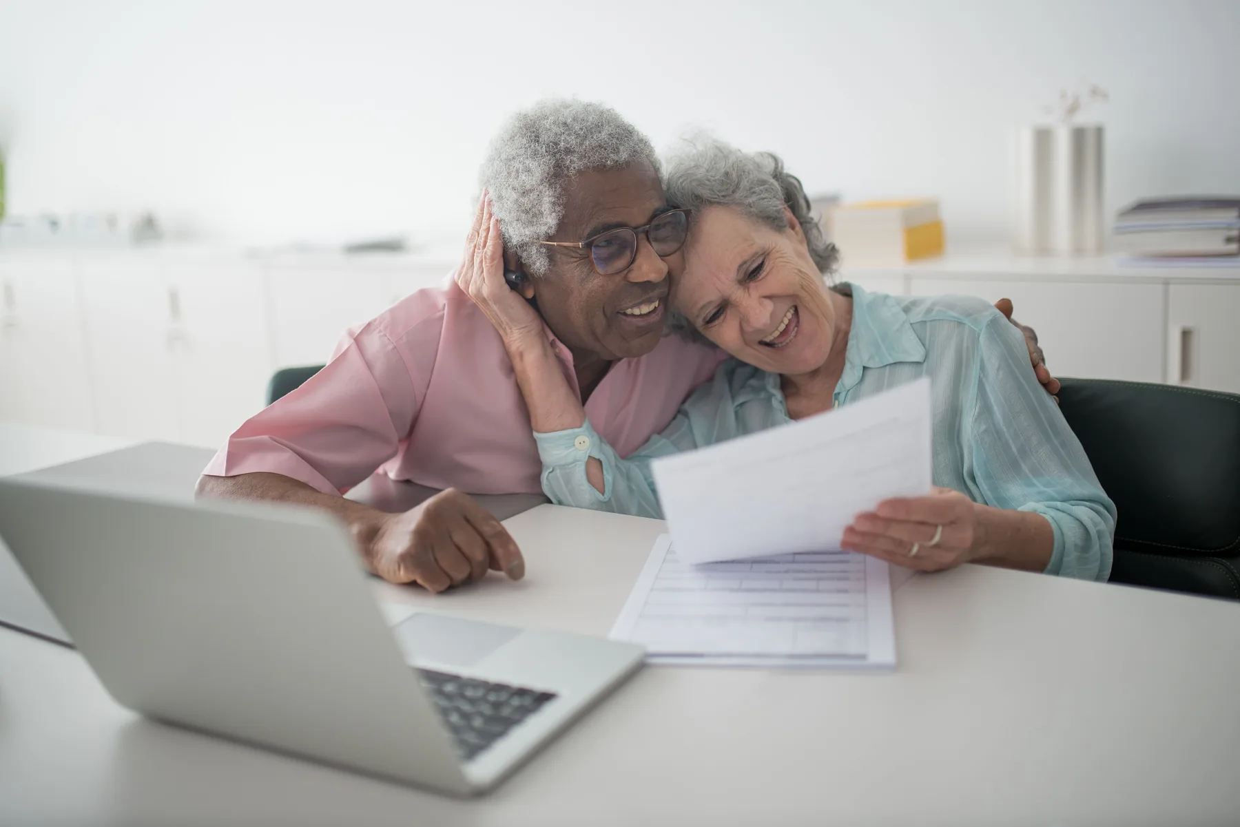 Smiling older couple reviewing documents together