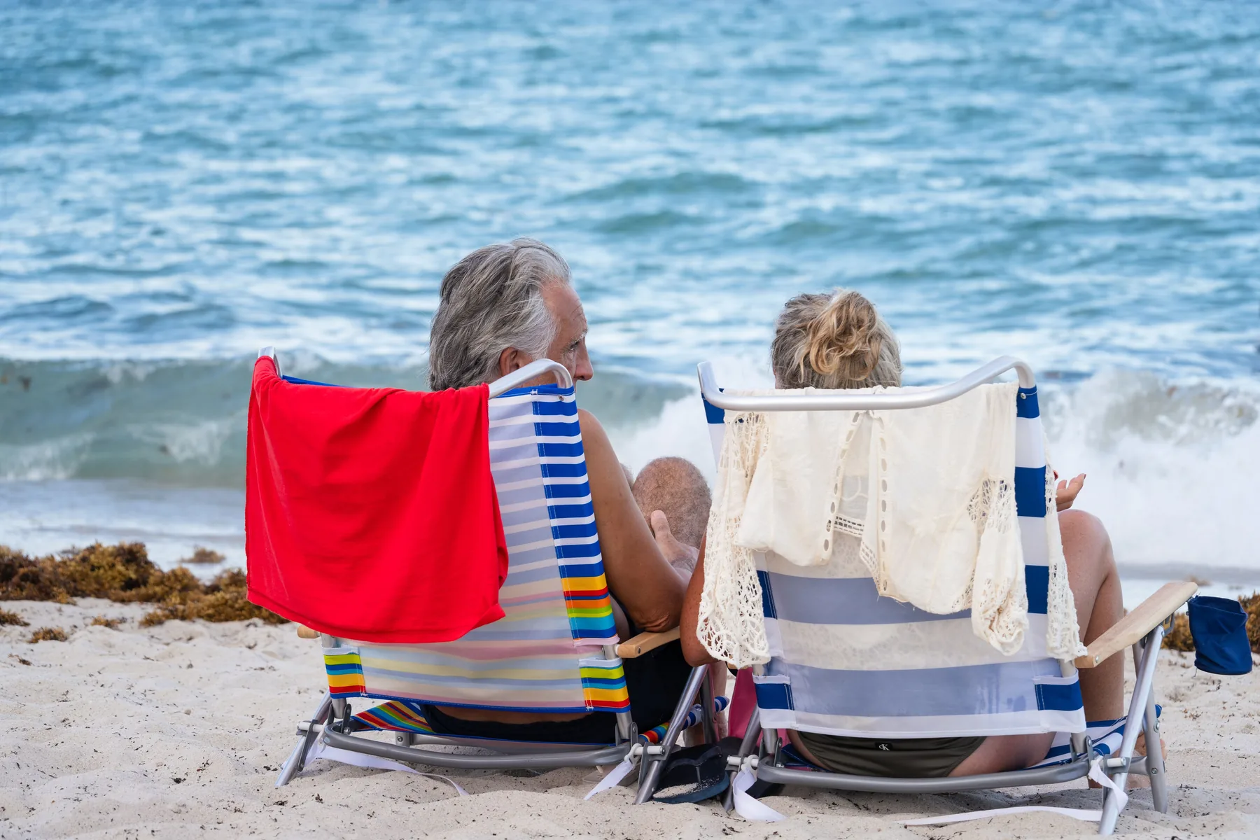 Older couple relaxing by the ocean in Miami Beach
